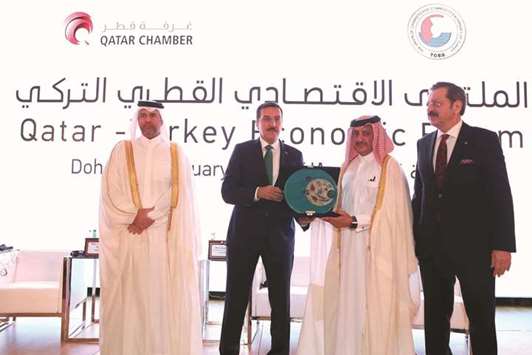 HE the Minister of Economy and Commerce Sheikh Ahmed bin Jassim bin Mohamed al-Thani witnesses the awarding of tokens between Qatar Chamber chairman Sheikh Khalifa bin Jassim bin Mohamed al-Thani and Turkeyu2019s Minister Customs and Trade Bulent Tufenkci. Looking on is the president of Union of Chambers and Commodity Exchanges of Turkey, Rifat Hisarciklioglu.