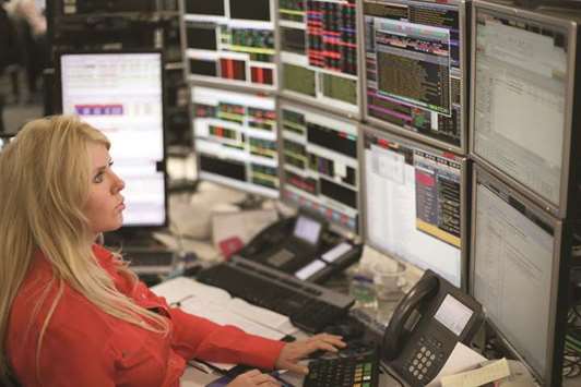 A trader is seen at the London Stock Exchange. The FTSE 100 lost 0.4% to 7,725.43 points yesterday.