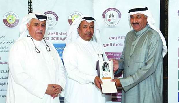 Director General of the General Directorate of Traffic Brigadier Saad bin Mohamed al-Kharji presenting a memento to Major General Fahad al-Shuwaei, assistant undersecretary of traffic affairs in Kuwait at the 5th Forum of the Stakeholder Co-ordinators of the Qatar Action Plan as NTSC Secretary General Brigadier Mohamed Abdulla al-Malki looks on.