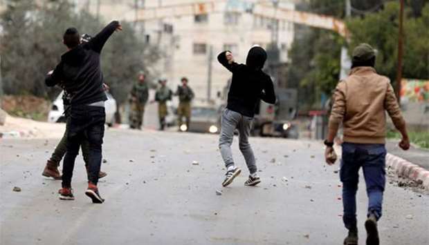 Palestinians hurl stones towards Israeli troops during clashes in Jenin on Thursday.