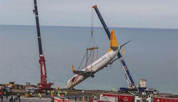 The Pegasus plane being lifted by cranes on Thursday, five days after it skidded off the runway just metres away from the sea as it landed at Trabzon's airport in northern Turkey.