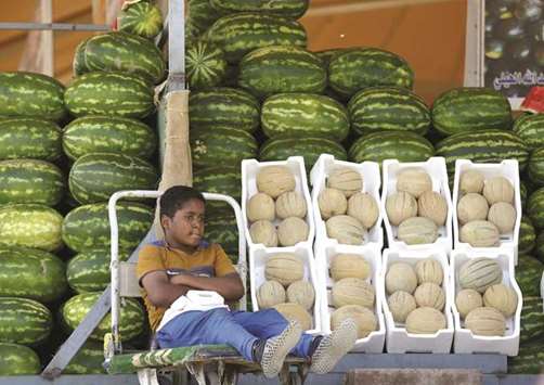 A Saudi boy sells melons and watermelons in Riyadh in this file photo dated on April 25, 2016. Saudi Arabiau2019s government expects record spending to deliver a strong economic rebound in 2018. Economists say itu2019s too optimistic, with officials underestimating the impact of new taxes, subsidy cuts and oil prices.