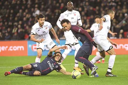 Paris Saint-Germainu2019s Neymar (right) and Edinson Cavani (left) dribble through the defence of Dijon players during the Ligue 1 match in Paris on Wednesday night. (AFP)