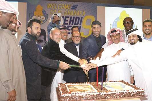 Al Gharafa officials cut a cake to welcome new recruit Iranian striker Mehdi Taremi to the club.