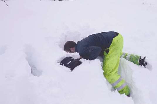 A man tries to locate his car buried in the snow in Leadhills, Scotland, yesterday.
