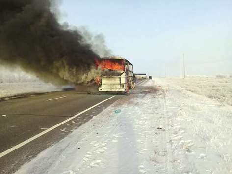 A handout picture provided by the Kazakh emergency situations ministry yesterday shows the burning bus on a road in the region around the city of Aktobe.