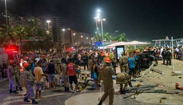 Paramedics help the injured after a vehicle ran over people at Copacabana beach in Rio de Janeiro,