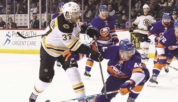 Patrice Bergeron (37) of the Boston Bruins scores against the New York Islanders at the Barclays Center in New York City on Thursday.
