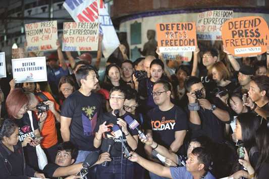 Maria Ressa (centre), the CEO and editor of online portal Rappler, speaks during a protest on press freedom along with fellow journalists in Manila, yesterday.
