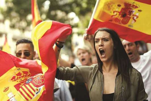 This picture taken on September 30 shows protesters with Spanish flags during a demonstration in Barcelona against independence in Catalonia.