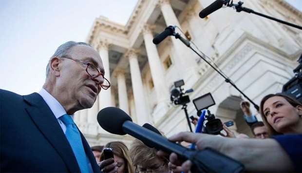 Senate Minority Leader Chuck Schumer speaks briefly with reporters