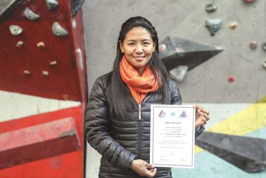 Dawa Yangzum Sherpa posing with a mountaineering certificate in Kathmandu.