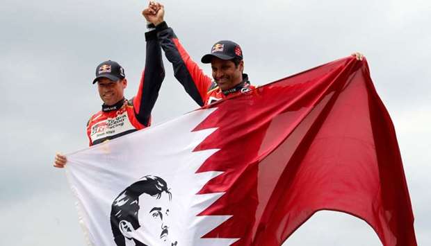 Nasser Al-Attiyah of Qatar and co-pilot Matthieu Baumel (L) of France celebrate after obtaining the second place of  2018 Peru-Bolivia-Argentina Dakar rally. Reuters