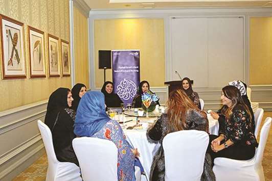 Bank official with Sadara members during an interaction event.