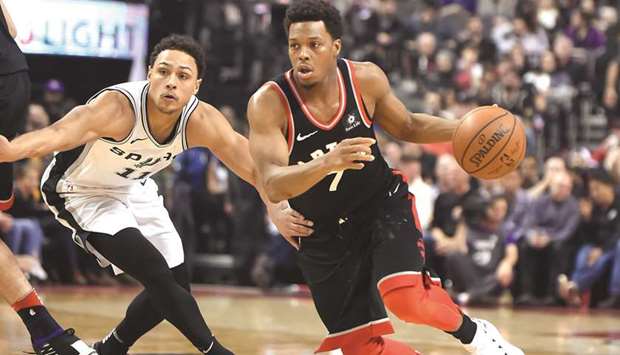 Toronto Raptors guard Kyle Lowry (right) dribbles the ball past San Antonio Spurs guard Bryn Forbes in the first half of their NBA game at Air Canada Centre in Toronto, Canada, on Friday. (USA TODAY Sports)