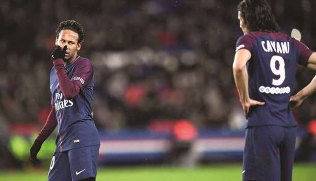 Paris Saint-Germainu2019s Neymar (left) talks to teammate Edinson Cavani prior to taking a free-kick against Dijon on Wednesday. (AFP)