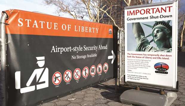 A sign announces the closure of the Statue of Liberty due to the US government shutdown yesterday.