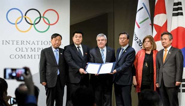 (From L) PyeongChang 2018 Olympics (POCOG) President Lee Hee-beom, North Korea's Sports Minister and Olympic Committee president Kim Il Guk, International Olympic Committee (IOC) President Thomas Bach, South Korean Minister of Culture, Sports and Tourism Do Jong-hwan, Swedish IOC member Gunilla Lindberg and South Korea's National Olympic Committee President Lee Kee-heung pose during a signing ceremony at the Olympic Musueum