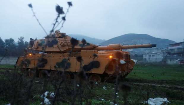 A Turkish military tank arrives at an army base in the border town of Reyhanli near the Turkish-Syrian border in Hatay province, Turkey on January 17.