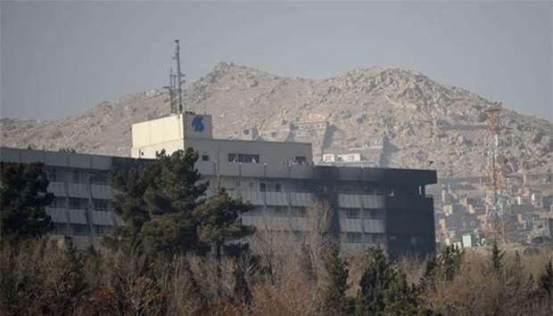 Afghan security personnel are seen on the rooftop of the Intercontinental Hotel after an attack in Kabul, on Sunday.
