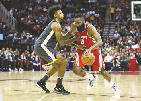 Houston Rockets guard James Harden (right) dribbles the ball as Golden State Warriors guard Nick Young defends during the second quarter of their NBA game at Toyota Centre. PICTURE: USA TODAY Sports