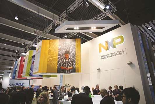 Visitors gather around the NXP Semiconductors pavilion at the Mobile World Congress in Barcelona in March 2015. Qualcomm can afford to pay more than the $110 a share being offered by NXP, Elliott said, adding that the company needs to complete the NXP deal to bolster growth.