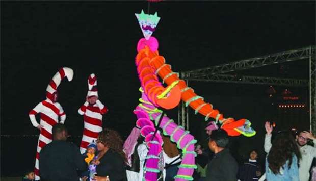 Stilt walkers entertain Katara visitors.