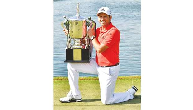 Sergio Garcia of Spain posing with the winneru2019s trophy following his victory in the Singapore Open at the Serapong golf course in Singapore yesterday. (AFP)
