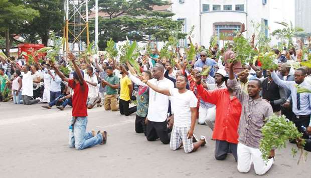 Demonstrators kneel and chant slogans during a protest organised by Catholic activists in Kinshasa yesterday.