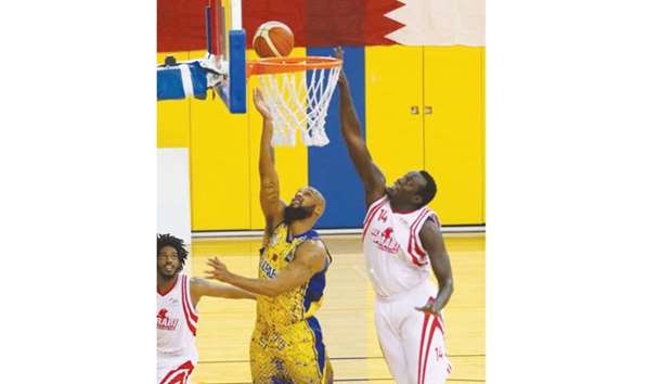 Al Gharafa (in yellow and blue) and Al Arabi players in action during their Qatar Basketball League match yesterday.
