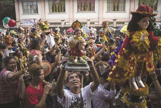 Devotees take part in the annual Santo Nino feast in Manila, yesterday.