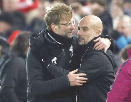 Liverpool manager Juergen Klopp (left) with Manchester Cityu2019s Pep Guardiola after the match last Sunday. (Reuters)