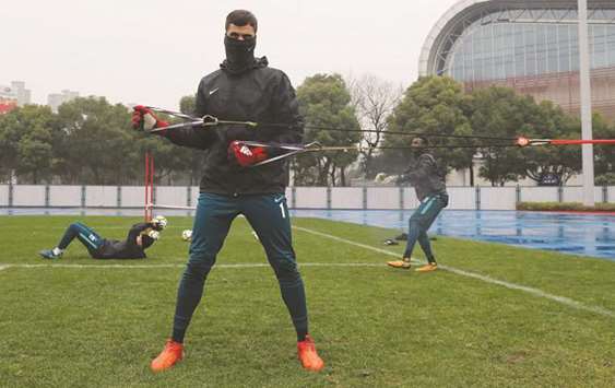 Qatari players warm up for Vietnam in cold Changzhou yesterday.