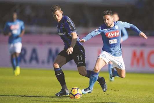 Napoliu2019s Dries Mertens (right) vies for the ball with Atalantau2019s Remo Freuler during the Serie A at the u2018Atleti Azzurri du2019Italia Stadiumu2019 in Bergamo, Italy, yesterday. (AFP)
