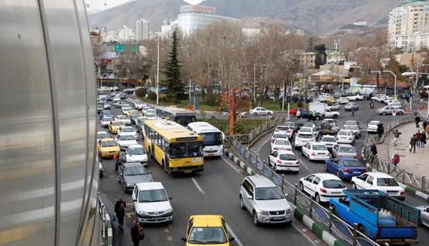 Iranians drive through Tajrish Square in the capital Tehran on January 2, 2018