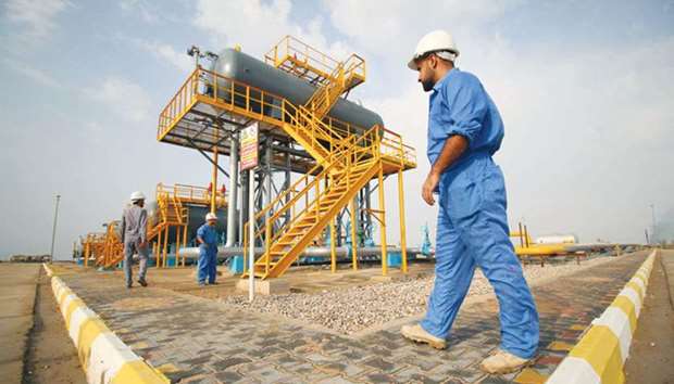 Iraqi labourers work at an oil refinery in the southern town of Nasiriyah (file). Oil exports from Iraqu2019s southern Basra ports rose to a record high of 3.535mn bpd in December from 3.5mn bpd the previous month, according to officials.
