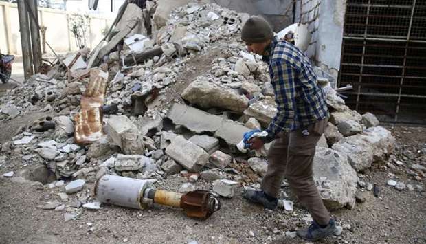 A man is seen near the remains of a rocket in Douma, Eastern Ghouta in Damascus, Syria