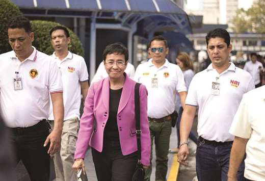 CEO of Philippine news website Rappler, Maria Ressa (centre), arrives at the National Bureau of Investigation (NBI) headquarters in Manila, yesterday.