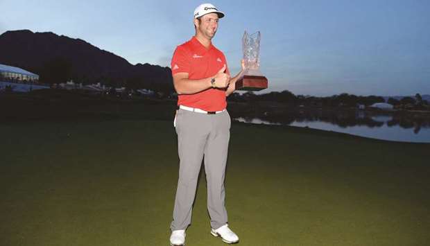 Jon Rahm of Spain poses with the trophy after putting in to win on the fourth hole of a sudden death playoff during the final round of the CareerBuilder Challenge at the TPC Stadium Course at PGA West in La Quinta, California. (Getty Images/AFP)