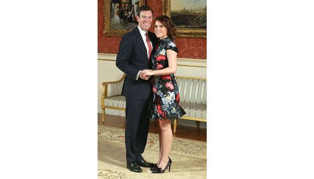 Princess Eugenie and Jack Brooksbank pose in the Picture Gallery after they announced their engagement, at Buckingham Palace, yesterday.