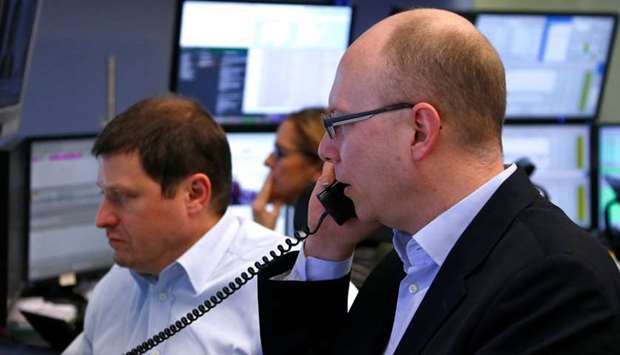 Traders are seen at the Frankfurt Stock Exchange. The DAX 30 gained 0.2% to 13,463.69 yesterday.