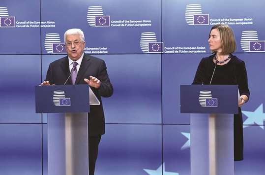 Palestinian President Mahmoud Abbas speaks as EU foreign policy chief Federica Mogherini listens prior to his attendance at the EU foreign affairs council in Brussels, yesterday.