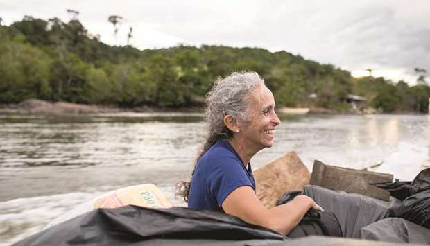 RIDE: Marianne Mayet, a teacher in French Guiana, takes a boat along the Oiapoque River that divides the French overseas department from Brazil.