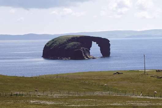 HORSE ISLAND: Just northwest of St. Magnus Bay, off the coast of the peninsula of Esha Ness, the tiny islet of Dore Holm is frequently compared to a horse taking a deep drink.