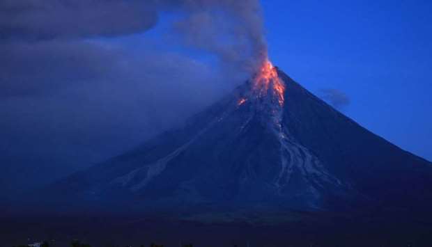 Lava spews from the Mayon volcano as it continues to erupt, seen from Legazpi City in Albay province