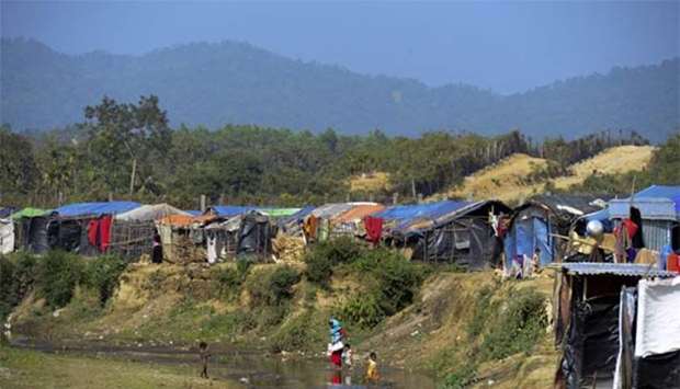 Rohingya refugees cross a canal next to a settlement near the 'no man's land' between Myanmar and Bangladesh in Tombru in Bangladsh's Bandarban district on Tuesday. The repatriation of hundreds of thousands of Rohingya Muslims who fled violence in Myanmar will not begin as planned, Bangladesh said on Monday.