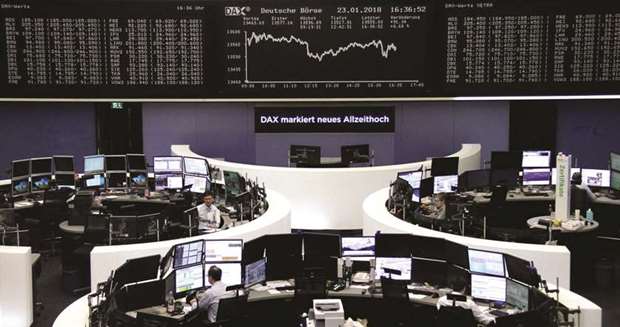 Traders are seen at the Frankfurt Stock Exchange. The DAX 30 jumped 0.7% to 13,559.60 points after a key survey showed surging German investor confidence in January.