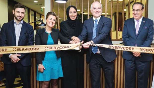 Servcorp senior manager Fabienne Hajjar, Qatar Business Incubation Centre CEO Aysha al-Mudahka and Australian ambassador Dr Axel Wabenhorst lead the ribbon-cutting ceremony during Servcorpu2019s launch event in Doha. Looking on are QBIC head of Incubation for Tourism Alain Valiquette and another senior official.