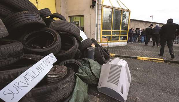 A placard reading u2018prison guards are angryu2019 is seen yesterday on a pile of tyres outside the Strasbourg-Elsau prison in Strasbourg, eastern France.