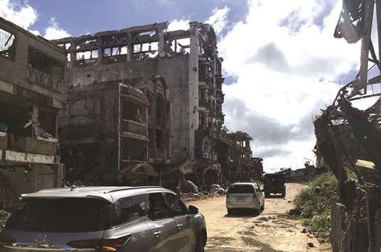 File photo shows a view of the facade, of the battered Landbank building, looted by militants, in the early days of the Marawi siege.